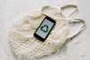 mobile-phone-with-green-recycling-sign-and-eco-mesh-bag