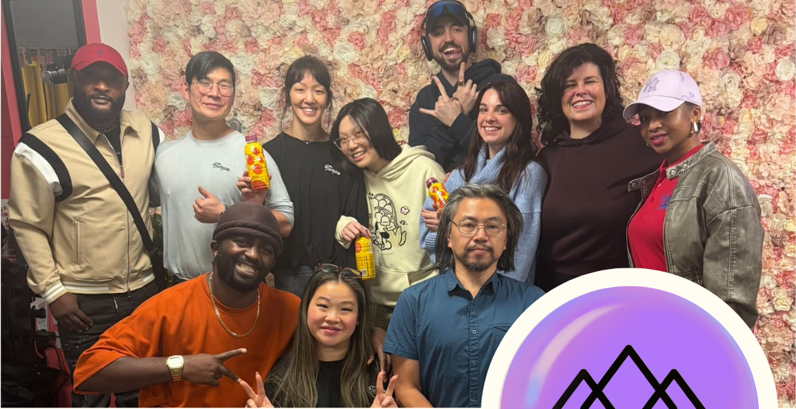 Group posing with Tempo drinks in front of a flower wall.